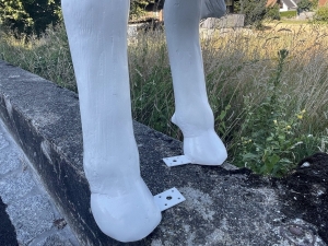 Detailaufnahme vom Vorderbein der weiss grundierten Kuhfigur.
